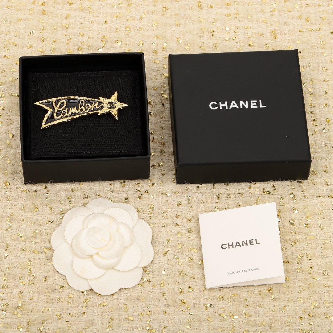 Chanel Black Gold Lettering Lava Star Brooches